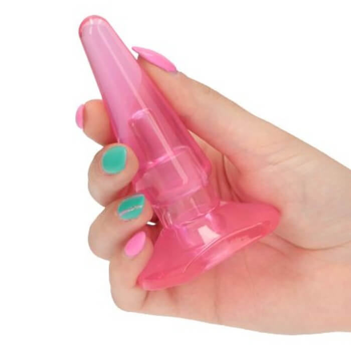 Żelowy korek analny marki Toyz4Lovers w kolorze różowym - ujęcie z dłonią